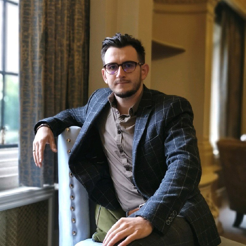 A professional headshot of Jakub Roszkowski, CBT Therapist